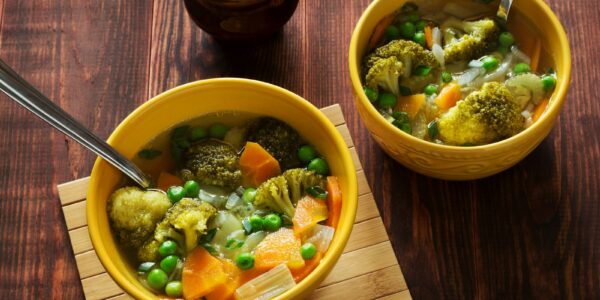 Bowls of homemade vegetable soup and broth