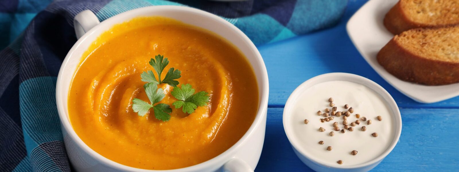 Creamy pumpkin and squash soup topped with pumpkin seeds