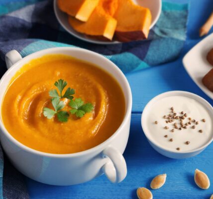 Creamy pumpkin and squash soup topped with pumpkin seeds