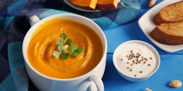 Creamy pumpkin and squash soup topped with pumpkin seeds