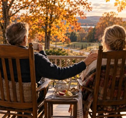 Two people share tea on a sunny autumn porch, a warm reminder of how loneliness and health are connected after 50
